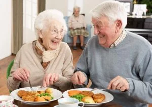 Older couple happily eating together