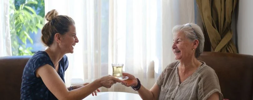 Team member having tea with resident