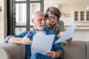 Older couple reading papers