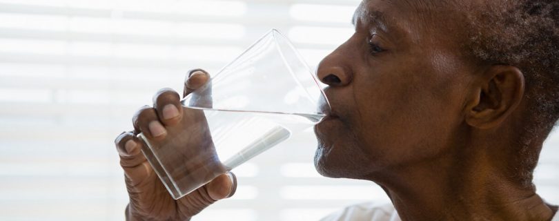 Older man drinking water